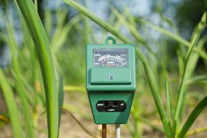 Measure soil with three way agricultural digital device photo