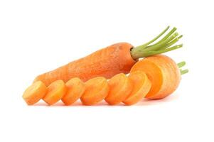 Whole carrot and its sliced pieces isolated against a white background photo