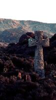 A mountain range with a serene cemetery cross nestled among the trees video