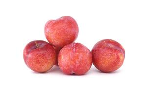 Four crimson plums isolated on white background photo