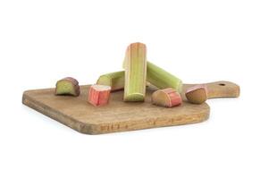 Rhubarb stalks of varying colors over white background photo