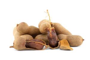 Tamarind whole and cracked open on white background photo