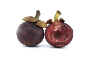 Purple mangosteen fruits isolated against a white background photo