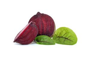 Slices of beetroot and fresh green leaves isolated on white photo