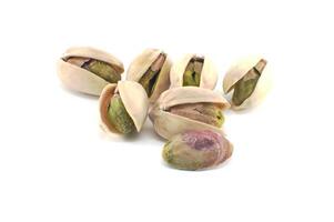 Randomly spread pistachios isolated on white photo