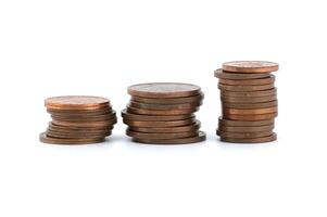 Stacks of coins ordered by size isolated on white photo