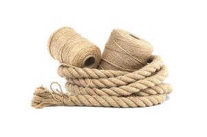 Various rolls of natural jute rope and twine isolated on white photo