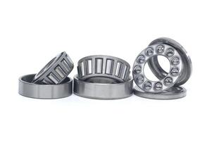 Tapered roller and thrust ball bearings isolated on white photo