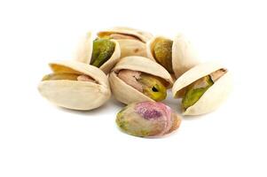 Randomly spread pistachios isolated on white photo