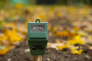 Measure soil with three way digital device photo