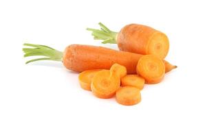 Whole carrot and its sliced pieces isolated against a white background photo