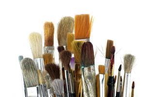 Assortment of various types and sizes of paintbrushes photo