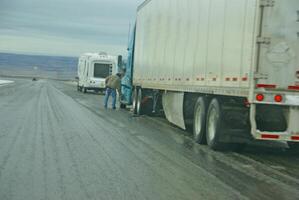 Trucks stop to remove chains photo