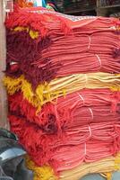 Stacks of red and yellow fabrics at the Ghanta Ghar photo