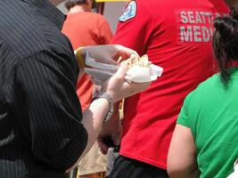 Eating a hot dog at a street fair photo