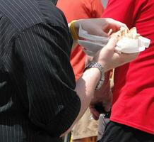 Eating a hot dog at a street fair photo