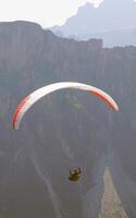 Parapentes launched from a high alpine meadow photo