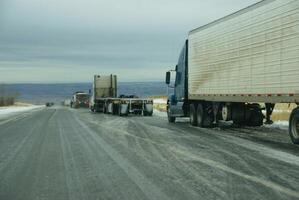 Trucks stop to remove chains photo