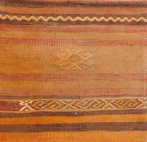 Turkish kilim with orange and brown, red patterns photo