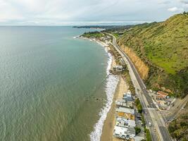 Highway Route 1 California. Aerial Panorama of the coastline and road. Green hills and beach on side photo