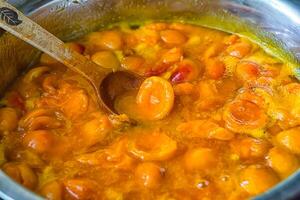 Apricot jam cooked in a bowl photo