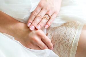 the hands of the bride dress up the stockings photo