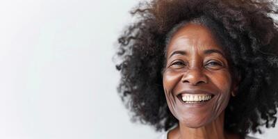 Elderly black African American woman smiling with copy space. Happiness, dark skin tone, white teeth, natural beauty, graceful aging concept photo