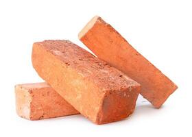 Side view of old cracked red or orange bricks in stack isolated on white background with clipping path. Construction materials photo