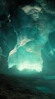 blue ice cave covered with snow and flooded with light video