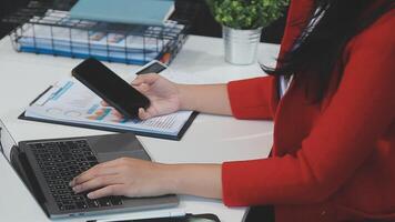 Asian Businesswoman Using laptop computer and working at office with calculator document on desk, doing planning analyzing the financial report, business plan investment, finance analysis concept. video
