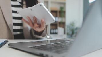 Asian Businesswoman Using laptop computer and working at office with calculator document on desk, doing planning analyzing the financial report, business plan investment, finance analysis concept. video
