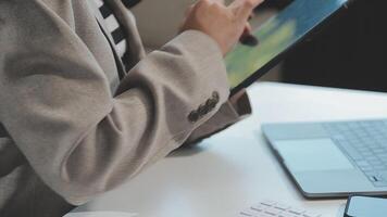 Asian Businesswoman Using laptop computer and working at office with calculator document on desk, doing planning analyzing the financial report, business plan investment, finance analysis concept. video