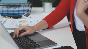Asian Businesswoman Using laptop computer and working at office with calculator document on desk, doing planning analyzing the financial report, business plan investment, finance analysis concept. video