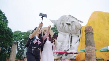 Two Asian women backpack are bloggers vlog creating temple trave video