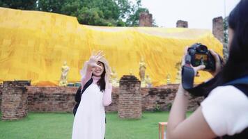 Two friends carried pack, toured Buddhism, and took happy pictures. During vacations video