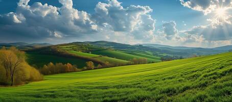 Summer landscape with meadow, hills, panorama of countryside in sunlight. Springtime landscape with grassy field and rolling mountains. Rural scenery photo