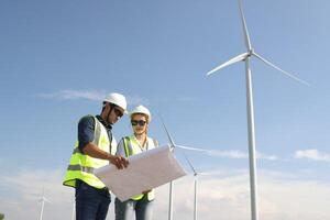 A couple of Electric engineers working together at a wind turbine farm. photo