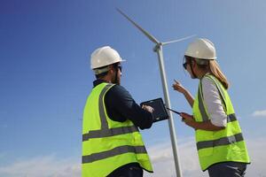A couple of Electric engineers working together at a wind turbine farm. photo