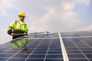 Cleaning solar panels with brush and water photo