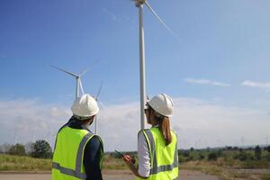 A couple of Electric engineers working together at a wind turbine farm. photo