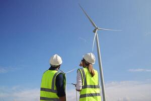 A couple of Electric engineers working together at a wind turbine farm. photo