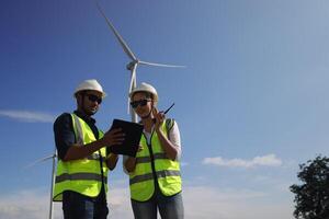 A couple of Electric engineers working together at a wind turbine farm. photo