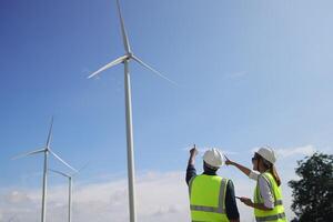 A couple of Electric engineers working together at a wind turbine farm. photo