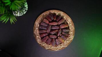 a plate with dates and a green plant video