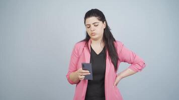 Stressed business woman, phone in hand and indecisive expression. video