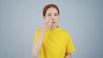 A woman trying to remove her make-up. video