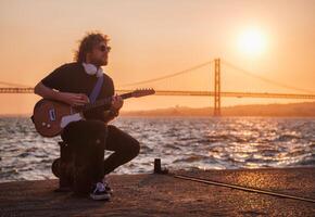 Street musician playing electric guitar in the street photo