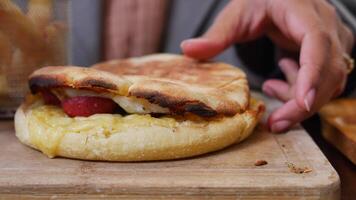 sandwich or toast with sausage served on a plate on tiles background video