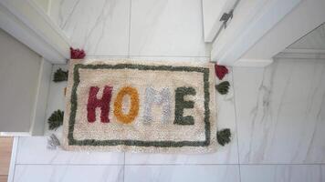 a rug with the word home written on it is on the floor in a hallway video