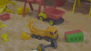 sand and colorful toys in a playground indoors. video